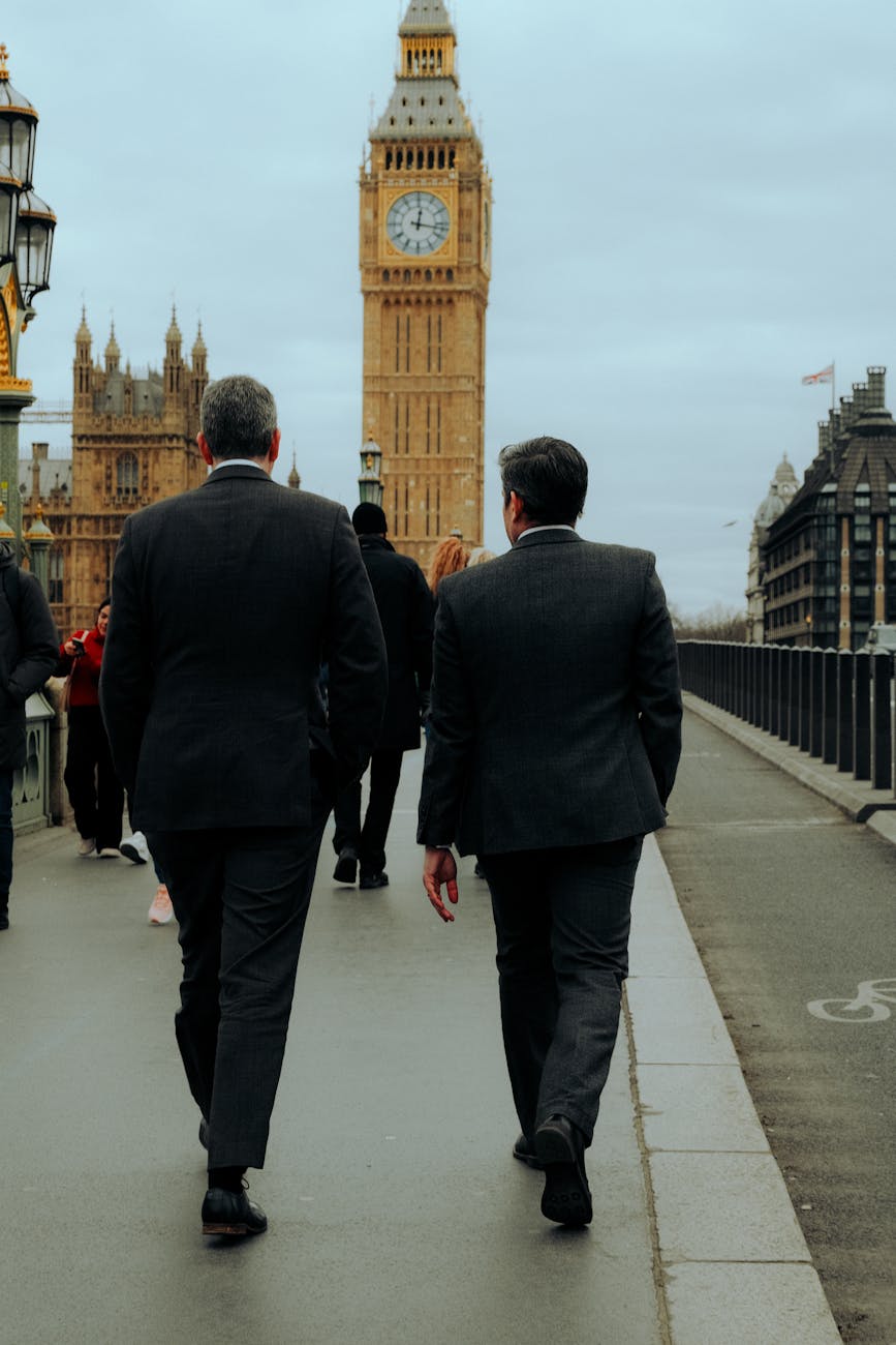 back view of two businessmen walking on a street